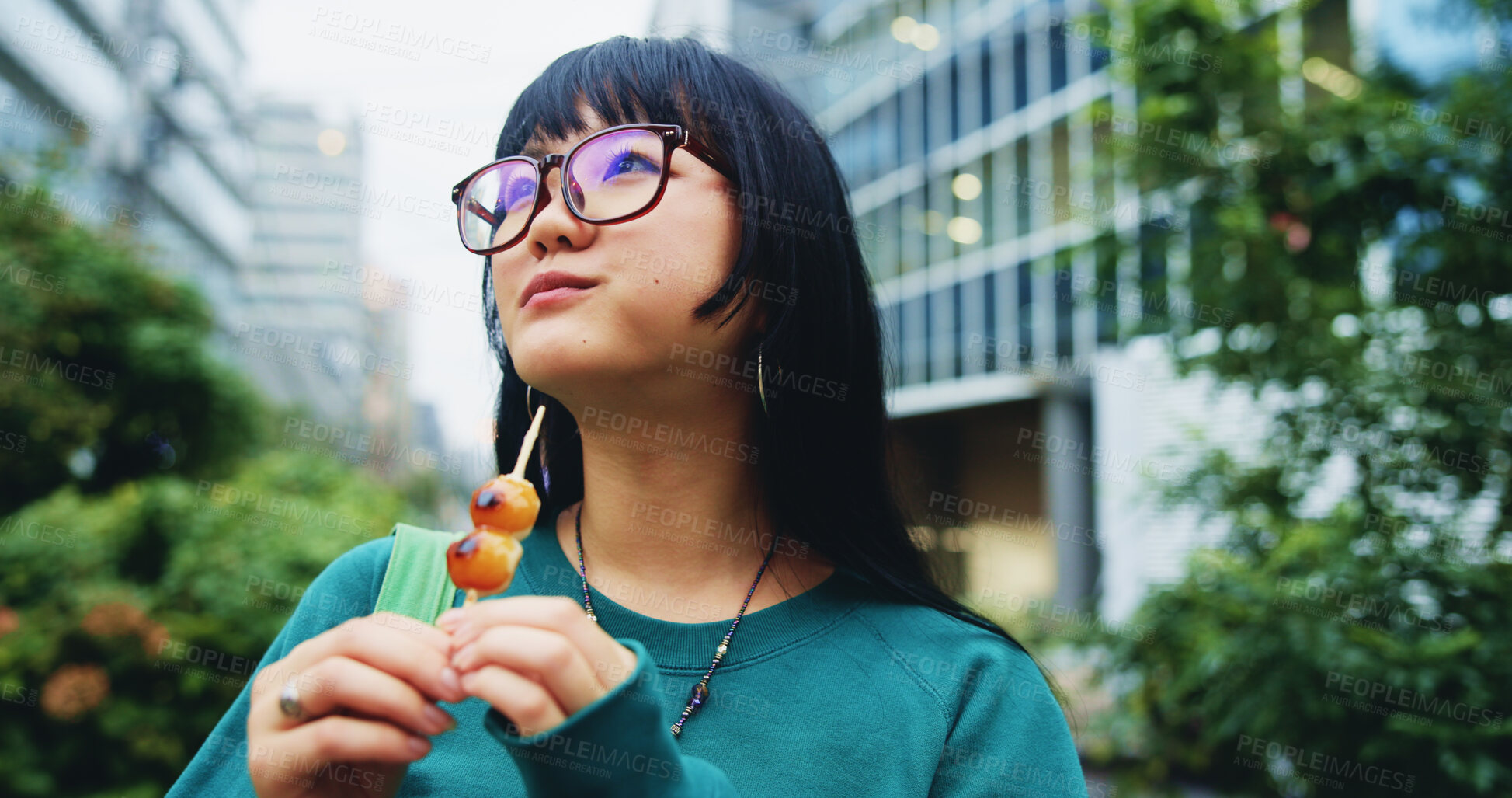 Buy stock photo Travel, eating and woman with snack in city on vacation, adventure or weekend trip for journey. Thinking, fun and hungry Japanese female person enjoying dango for dessert in urban town on holiday.