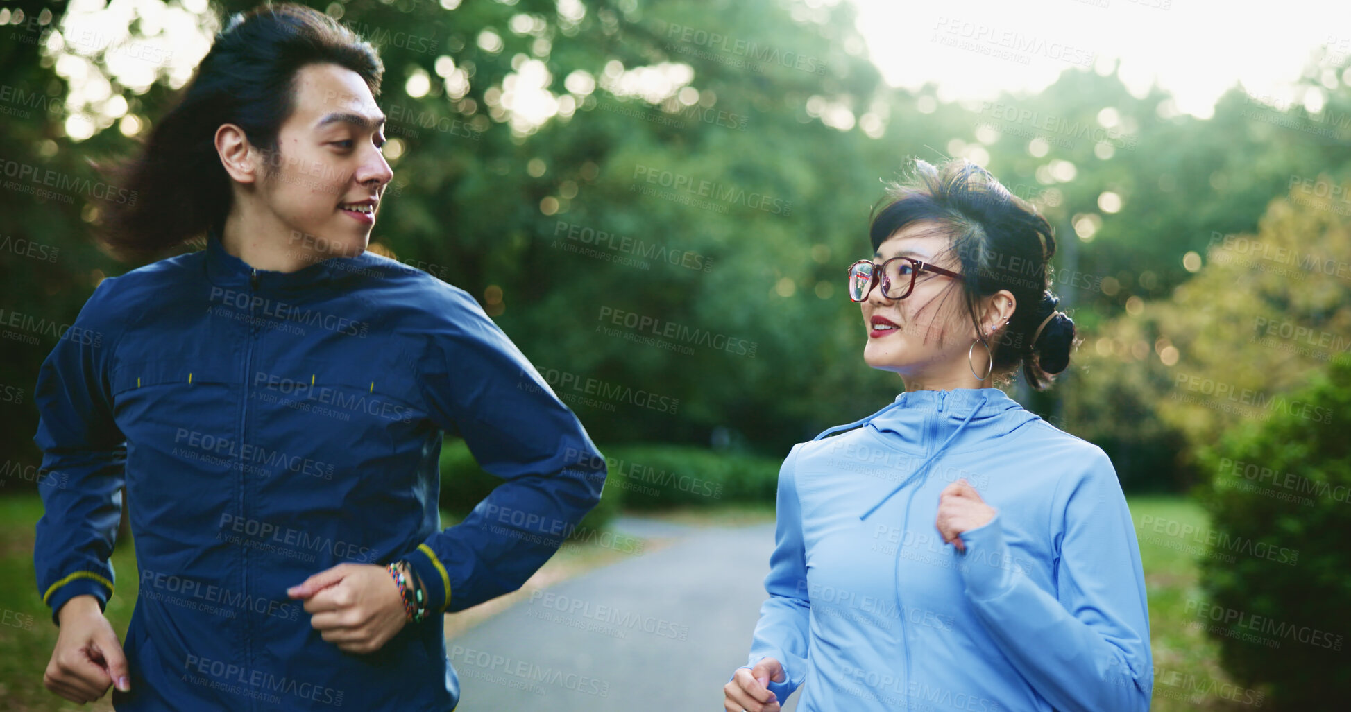 Buy stock photo Park, couple and happy with running for fitness for self care, wellness and health in Japan. People, outdoor and jogging with smile at forest for exercise, cardio. and workout with support and love