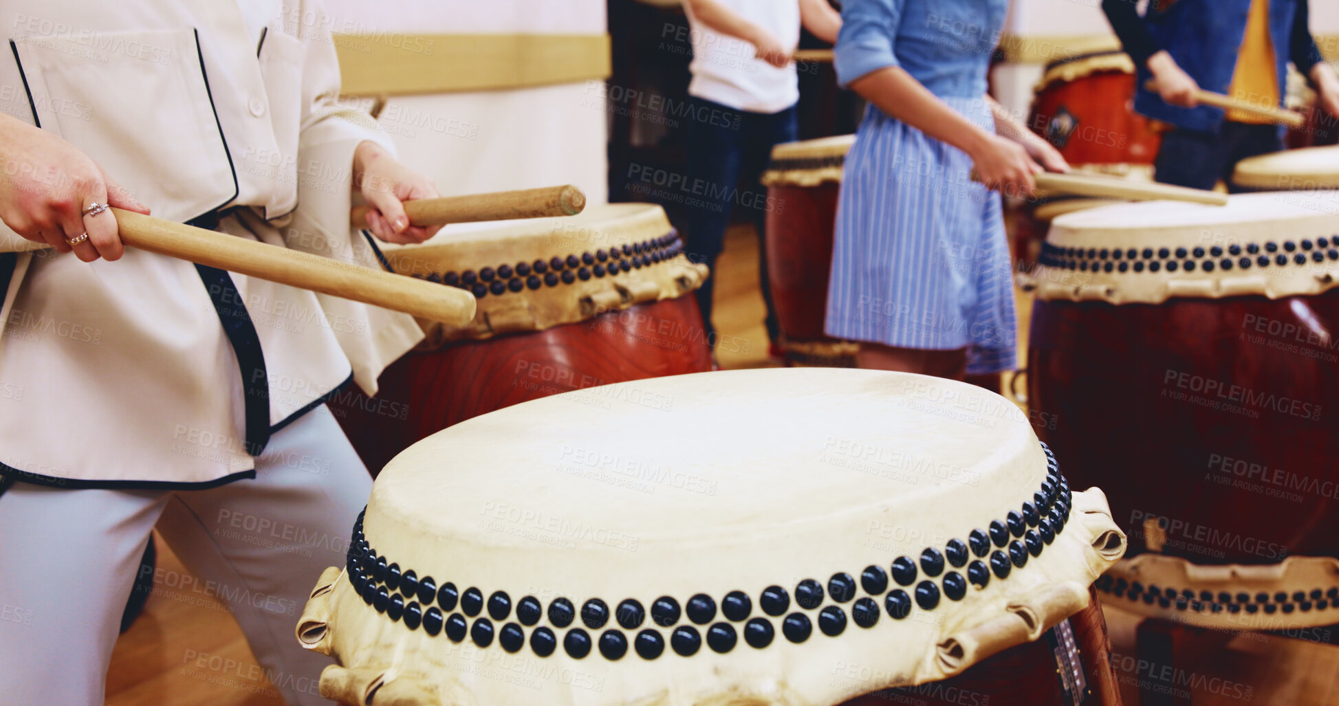Buy stock photo Japanese, drums and hands of people in performance for music on instrument for stage practice or creativity. Taiko, learning song and drummers in band to play in rehearsal for culture, rhythm or beat