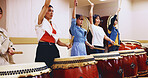 Japanese, drums and women in performance for music on instrument for stage practice, creativity or talent. Taiko, people and female drummers in band to play in rehearsal for culture, rhythm or beat