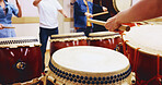 Japanese drums, hands and people with sticks on instrument for stage practice, performance or talent. Taiko, class and drummers in band to play in rehearsal for culture, song rhythm or creative beat