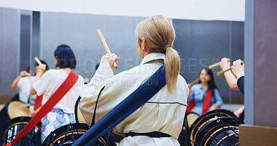 Buy stock photo Japanese, back and people with drums for music on instrument for performance, practice and class. Taiko, women or female drummers learning in band to play in rehearsal for culture, rhythm or beat