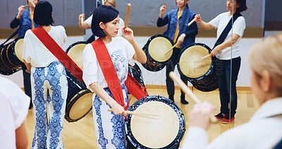 Buy stock photo Japanese, learning or people with drums for music on instrument for performance, creativity or class. Taiko, woman or female drummers in band to play in practice rehearsal for culture, rhythm or beat