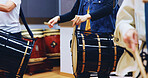 Japanese, drums and hands of people in culture for music on instrument for stage practice or creativity. Taiko, learning song and drummers in band to play in rehearsal for tradition, rhythm or beat