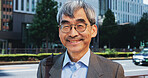 City, mature and portrait of employee man outdoor in Japan for morning commute or travel to work. About us, business and glasses with smile of happy Japanese person in urban town for corporate career