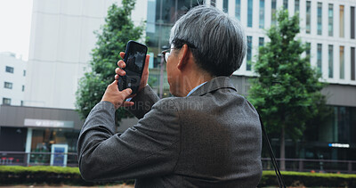 Buy stock photo Outdoor, businessman and photography with smartphone in city for infrastructure development project in Japan. Mature person, employee and property developer in downtown for architect design and ideas