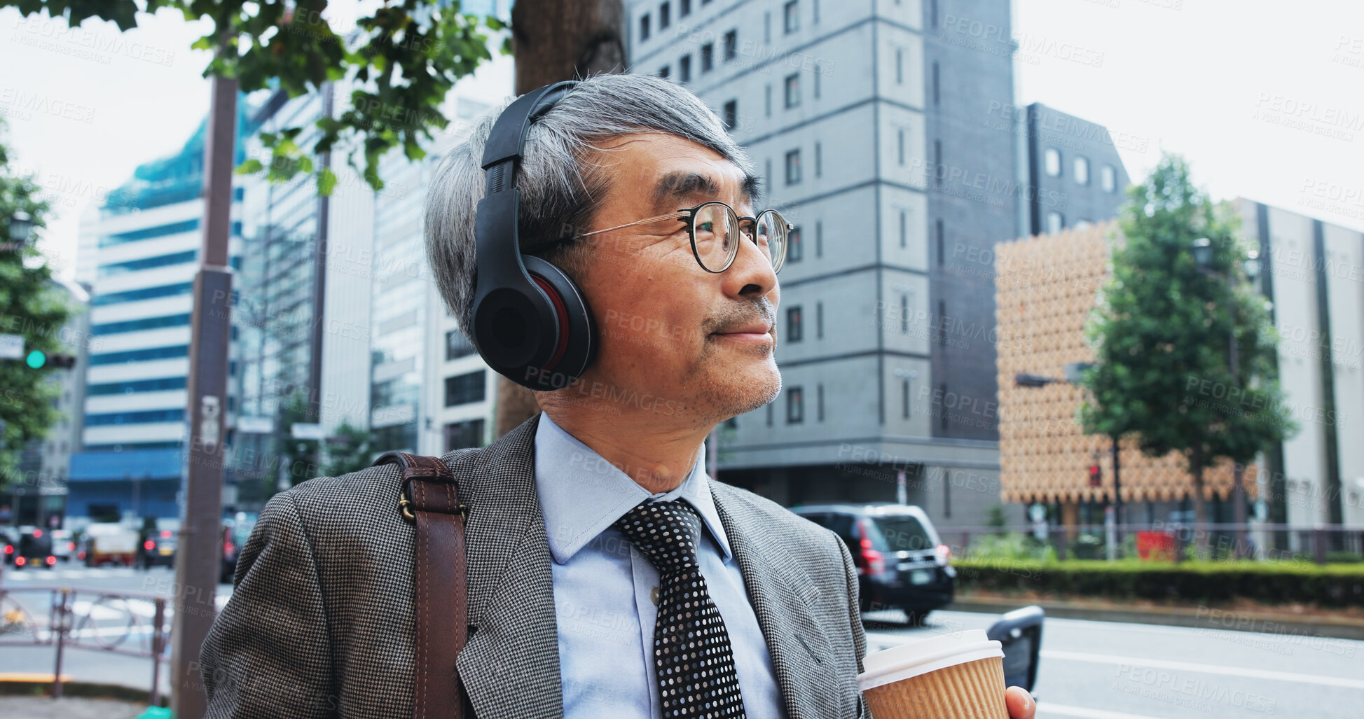 Buy stock photo Mature businessman, headphones and thinking for street, commute and music with subscription on Tokyo trip. Japanese person, drink and walking to workplace with podcast, streaming and urban japan road