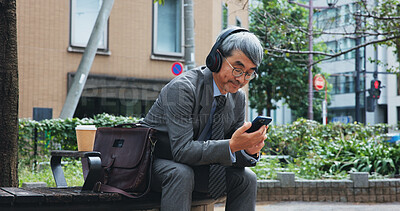 Buy stock photo Business, phone and music with mature man outdoor in city for break from job or work. App, headphones and travel with corporate Japanese employee outdoor in urban town for communication or streaming