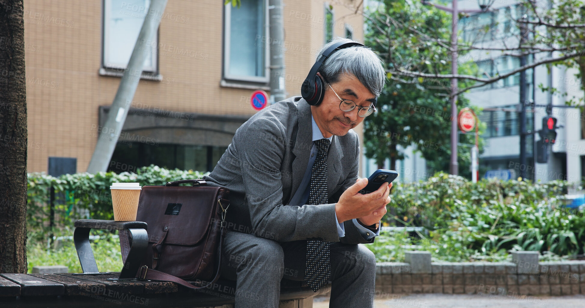 Buy stock photo Business, phone and music with mature man outdoor in city for break from job or work. App, headphones and travel with corporate Japanese employee outdoor in urban town for communication or streaming