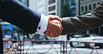 Handshake, business people and men in city, partnership and agreement with b2b deal. Japan, closeup and employees in street, cooperation and negotiation with contract, collaboration and opportunity