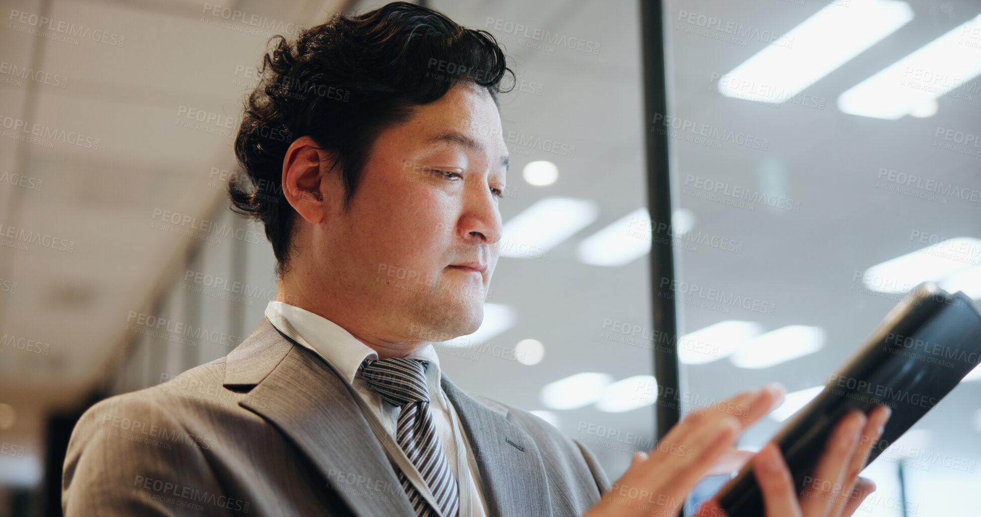 Buy stock photo Business, man and typing on tablet in office for portfolio management, funding proposal review or reading info. Japanese firm, budget analyst and digital technology for contract agreement or planning