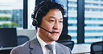 Call center, headset and Japanese man in agency for customer service, technical support or consulting. Male person, microphone and telecommunication for advice, conversation and feedback as help desk