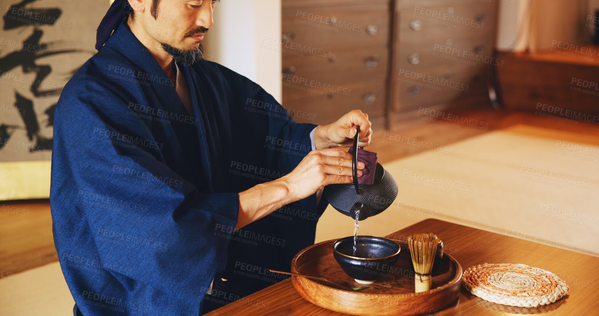 Buy stock photo Man, relax and tea ceremony for culture, tradition and matcha in home with preparation in Japan. Male person, ritual and bowl for mindfulness, zen and buddhism with spiritual, respect and harmony