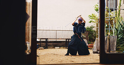 Buy stock photo Dojo, sword and training with Samurai man in Japan for fighting, martial arts or Kenjutsu, Combat, culture and weapon with Japanese person in kendogi for discipline, exercise or practice routine