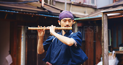 Buy stock photo Japanese man, flute and music for practice, reflection and zen sound for Shinto meditation. Sensei person, bamboo and fue instrument for tradition, culture and spiritual heritage with shinobue