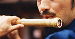 Japanese man, mouth and music for flute practice, performance and zen sound for Shinto meditation. Sensei person, bamboo and fue instrument for tradition, culture and spiritual heritage with shinobue