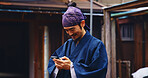 Japan, outdoor and man with smartphone, typing and smile with network, happiness and social media. Asian person, kimono and guy with cellphone, internet and connection with message to contact and app