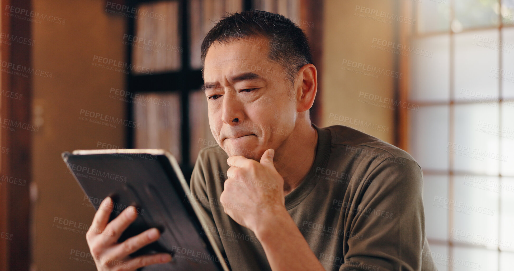 Buy stock photo Tablet, thinking or Asian man in home reading for remote work, research or website in Japan. Face, mature author or creative freelancer with touchscreen for online campaign, article ideas and project