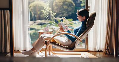 Buy stock photo Reading, chill and Asian woman with book, morning and knowledge with literature, relax or weekend. Home, peace and person with novel, rest and comfortable with story, break and cozy on chair or Japan