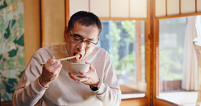 Buy stock photo Asian man, eating and food with chopsticks for healthy meal, snack or delicious noodles at home. Japan, male person or bite with bowl or utensils for dining tradition, culture or heritage at house