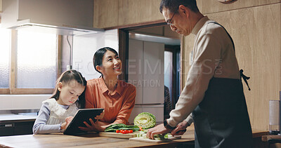 Buy stock photo Mom, girl and tablet in kitchen with dad, cooking and happy with streaming, recipe and teaching in family home. People, mother and daughter with touchscreen, food and meal prep at house in Japan