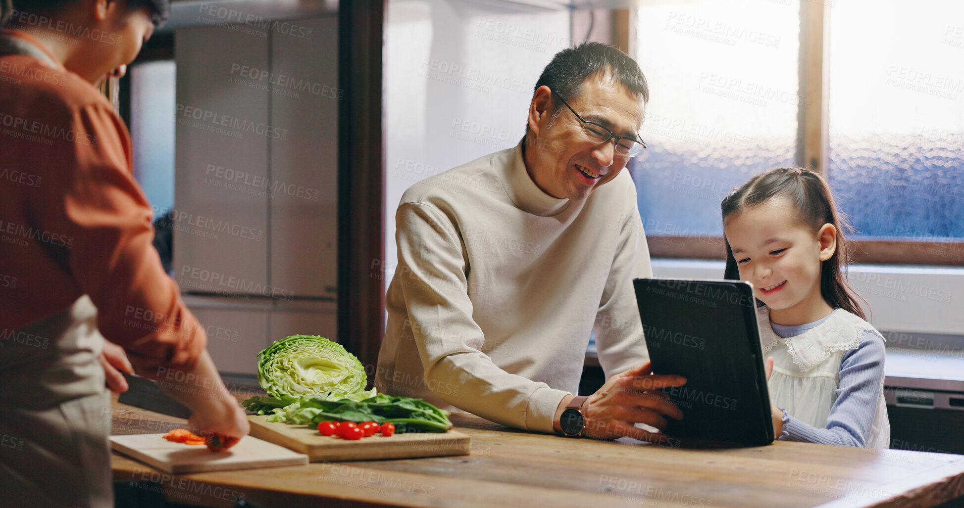 Buy stock photo Dad, girl and tablet in kitchen with mother, cooking and happy with streaming, video or movie in family home. People, father and child with digital touchscreen for cartoon movies at house in Japan