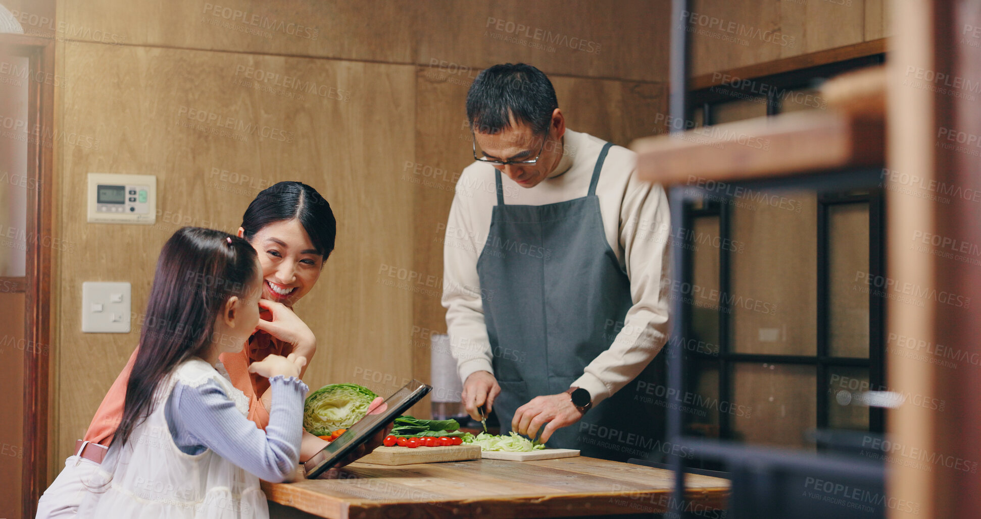 Buy stock photo Parents, girl and tablet in home with cooking, learning and happy with food, tutorial and recipe in kitchen. People, mother and daughter with dad, touchscreen and meal prep at family house in Japan