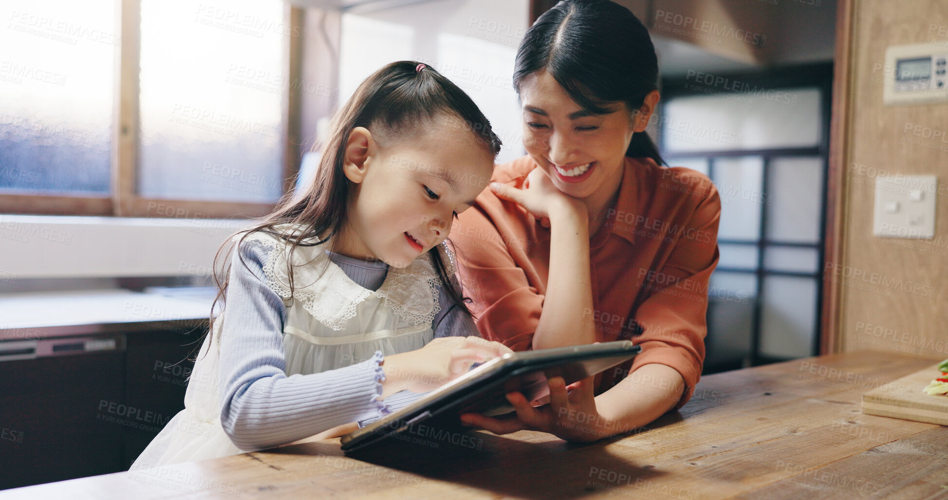 Buy stock photo Mom, girl and tablet in home with smile, learning and bonding with application for e learning. People, mother and daughter with touchscreen, education and online course at family house in Japan