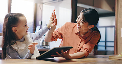 Buy stock photo Mom, girl and tablet in home with high five, smile or support with application for e learning. People, mother and daughter with goals, education or success with online course at family house in Japan