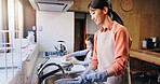 Mom, girl and washing dishes in home with smile, learning and helping hand for hygiene in kitchen. People, mother and daughter with routine, teaching and happy for cleaning at family house in Japan