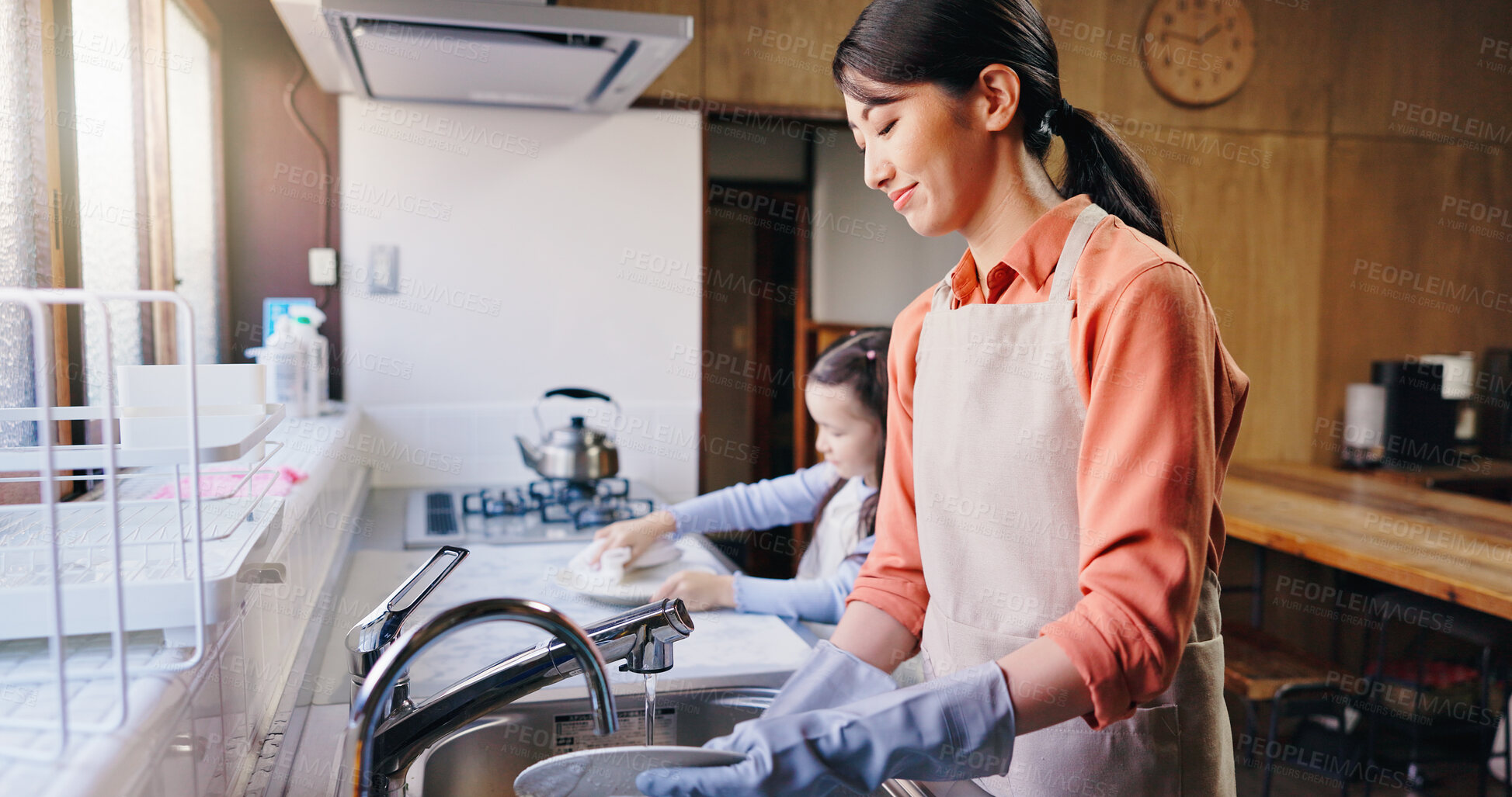 Buy stock photo Mom, girl and washing dishes in home with smile, learning and helping hand for hygiene in kitchen. People, mother and daughter with routine, teaching and happy for cleaning at family house in Japan