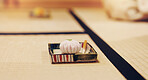 Serving, ceremony and sweet with wagashi on tatami floor for traditional, Japanese delicacy and zen. Home, wellness and culture with chakaiseki in chashitsu room for season, event and Hatsugama