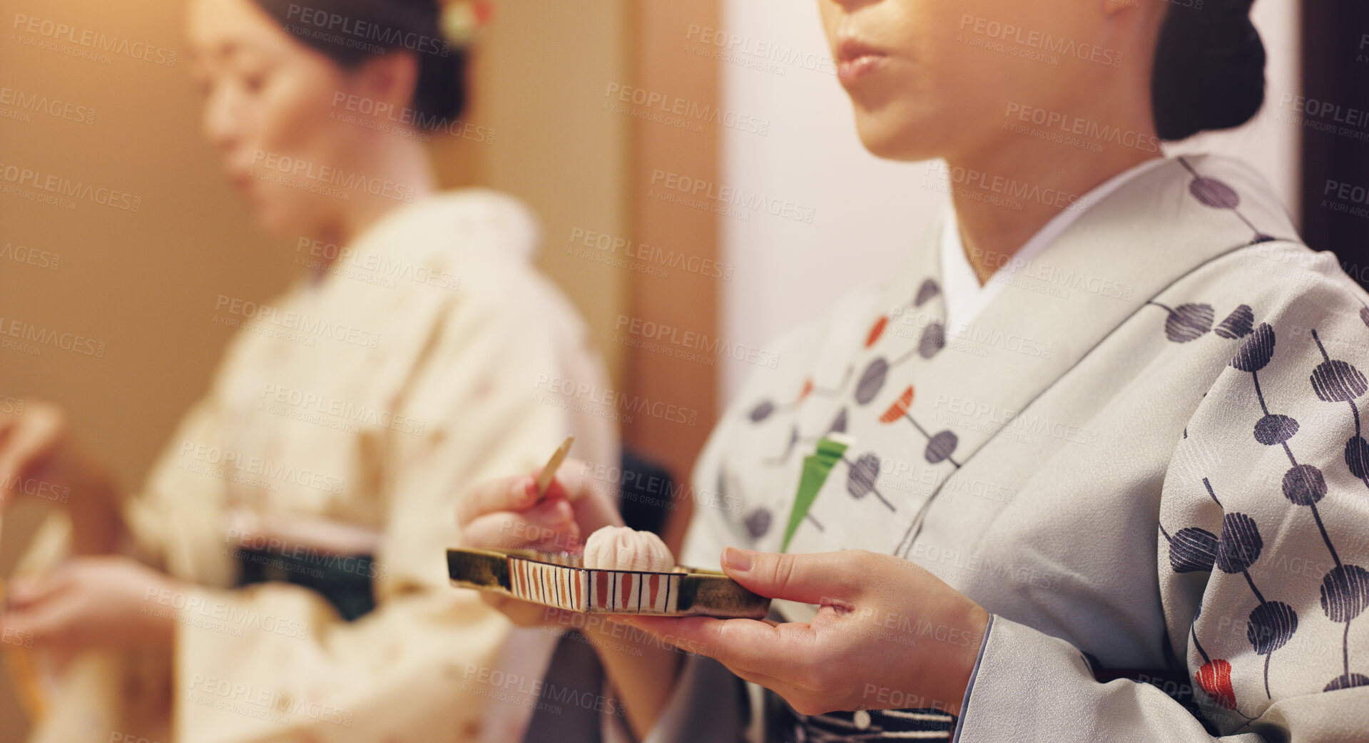 Buy stock photo Tea, ceremony and women in kimono with sweets, Asian food culture and hospitality service on travel. Traditional clothes, wagashi and hands of girl friends eating Japanese dessert at event together