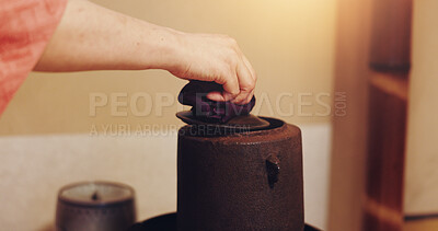 Buy stock photo Hand, Japanese tea and teapot in home, traditional and matcha with antioxidants, ceremony and herbal. House, person and beverage to detox, health benefits and recipe for ocha, indigenous and Japan