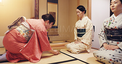 Buy stock photo Tea room, hostess and serving ceremony with women, wellness and traditional kimono for culture. Chawan, guests and bowl with cultural outfit for matcha drink, process and respect for home hospitality