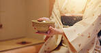 Hands, hostess and woman with bowl, chawan and traditional kimono for tea ceremony. Japanese ritual, spirituality and mindfulness with cultural outfit for matcha drink, respect and home hospitality