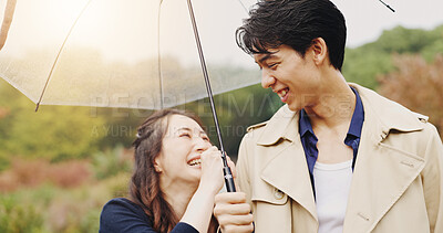 Buy stock photo Love, umbrella and laughing with Japanese couple in park for romance, bonding and relationship. Support, funny and happiness with man and woman in Japan nature for date, commitment and peace