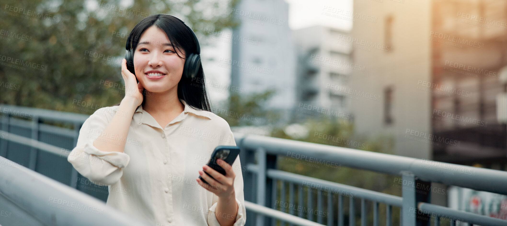 Buy stock photo City, happy woman and headphones for music with phone for streaming podcast on app or travel. Mobile, outdoor and Japanese girl listening to audio online, sound and thinking of jazz playlist on radio