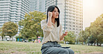 City, woman and earphones for music, relax and streaming podcast with wireless technology. Japanese girl, outdoor and listening to audio online, sound and thinking of jazz playlist on radio at park