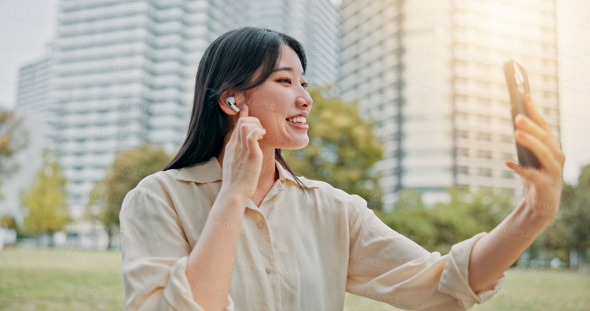 Buy stock photo Happy, asian woman and video call with earphones in city for communication, conversation or chat. Japan, female person or talking with mobile smartphone for virtual discussion or app in an urban town