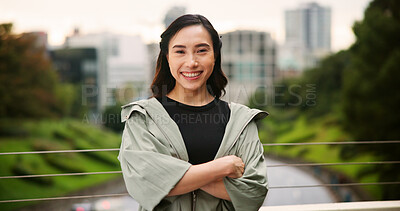 Buy stock photo Arms crossed, city and fitness with portrait of woman outdoor for cardio or marathon training routine. Bridge, exercise and smile of happy Japanese sports athlete or runner for health or wellness