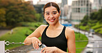 City, fitness and water with portrait of woman outdoor for cardio or marathon training routine. Exercise, hydration and smile of sports athlete or runner on bridge in Japan for health or wellness