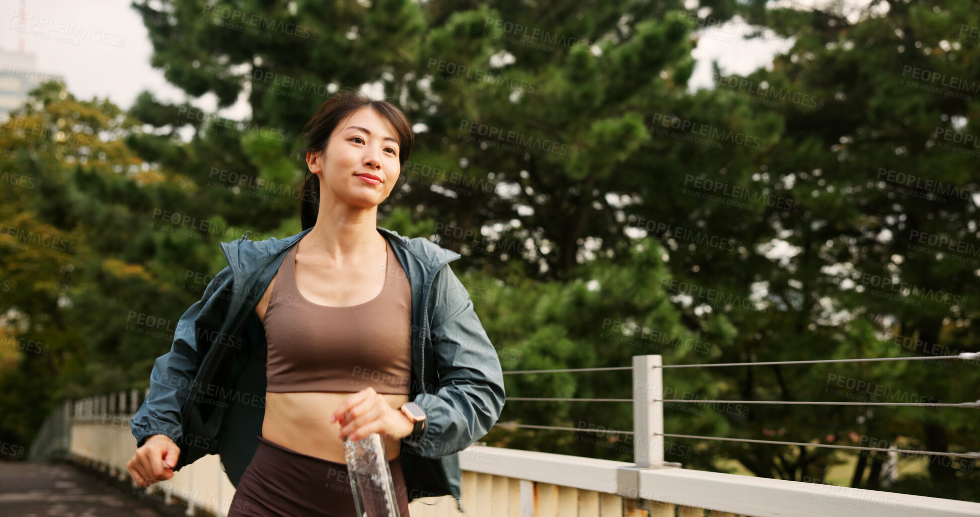 Buy stock photo Outdoor, woman and smile on bridge for running with water bottle for fitness, workout and exercise in Japan. Female person, city and happy with jogging for health, self care and wellness routine