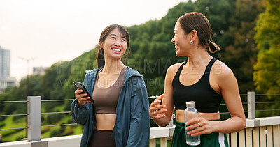 Buy stock photo Fitness, happy friends and girls walking at park, talking or communication on phone. Japanese women, sports and  outdoor together for body health conversation, exercise or gossip on break with bottle