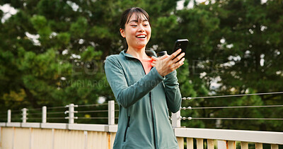 Buy stock photo Outdoor, woman and runner with smartphone, smile and texting with fitness influencer. Japanese person, girl and athlete with cellphone, message to contact and social media with connection and app