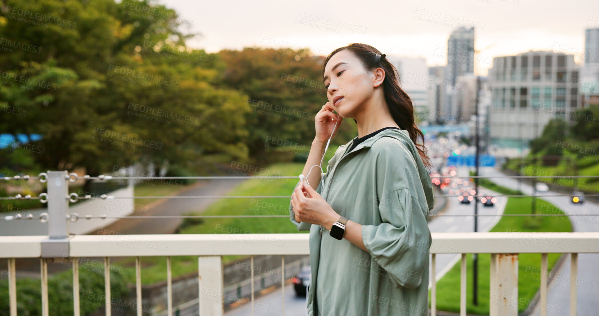 Buy stock photo Fitness, city and Asian woman with music earphones for running, outdoor training and sports routine. Exercise, podcast and Japanese female runner on bridge with radio, track and song audio in Japan