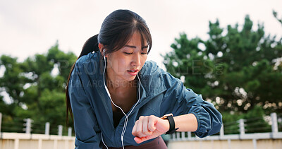 Buy stock photo Fitness, smart watch and woman at park with music, exercise info or track progress on time app. Sports, workout or Japanese person with wristwatch, earphones or monitor pulse for body health on break