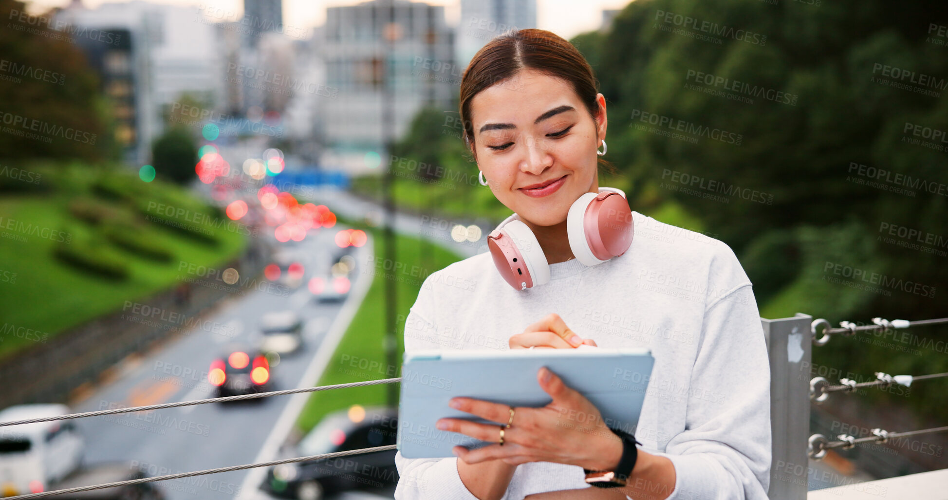 Buy stock photo Japanese woman, writing and tablet in city for graphic design, digital illustration and creative process. Female artist, headphones and drawing for website, editing update and project on Japan bridge