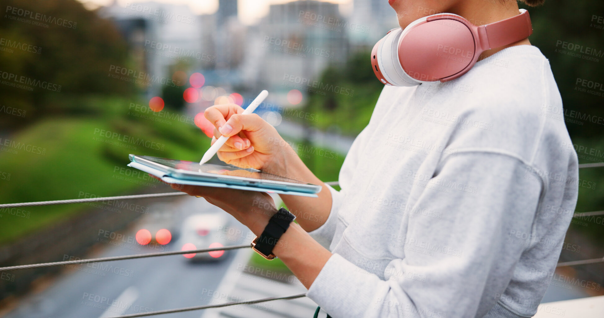 Buy stock photo Hands, person and writing on tablet in city for copywriting, reading article and publishing process. Writer, headphones and pen of newsletter blog of story, editing update and project on Japan bridge