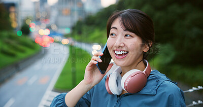 Buy stock photo Happy, Japanese woman and phone call in city of fitness conversation, sports membership and weekend plan. Smile, person and headphones of mobile discussion, gym contact and urban chat on Japan bridge